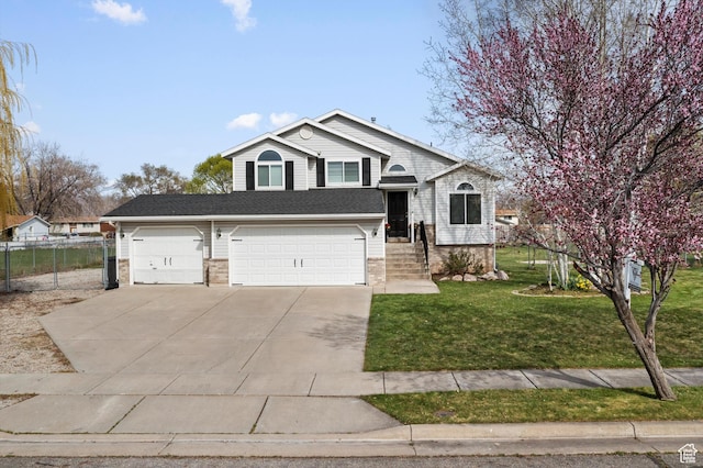 2124 N 2525 W, Clinton, UT 84015 - tri-level home featuring an attached garage, driveway, fence, and a front lawn