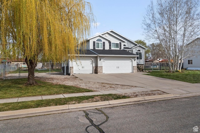 2124 N 2525 W, Clinton, UT 84015 - view of front facade with concrete driveway, an attached garage, fence, and a front lawn