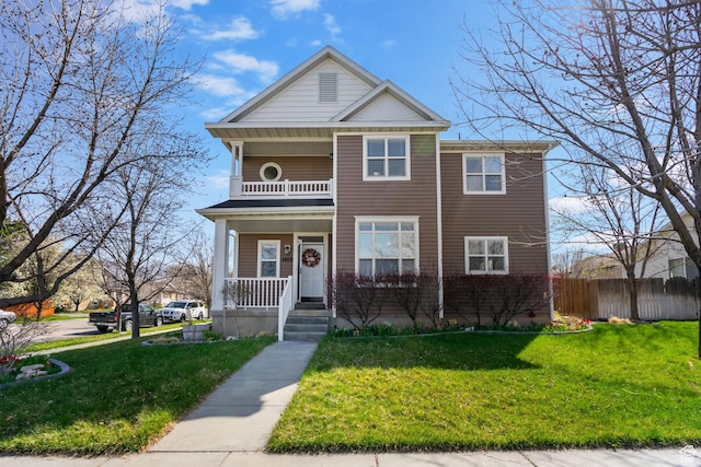 1468 N 220 W, Tooele, UT 84074 - view of front facade with a porch, a balcony, fence, and a front lawn