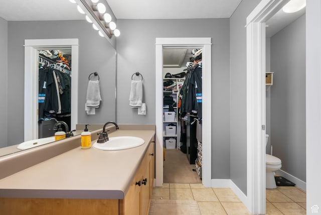1468 N 220 W, Tooele, UT 84074 - bathroom featuring vanity, a spacious closet, toilet, tile patterned floors, and baseboards