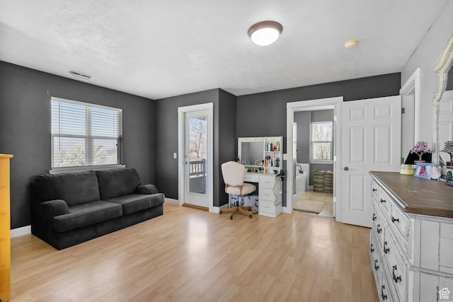 1468 N 220 W, Tooele, UT 84074 - living area featuring light wood finished floors, baseboards, and visible vents