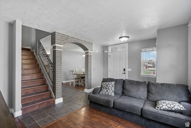 1468 N 220 W, Tooele, UT 84074 - living area with arched walkways, baseboards, dark wood finished floors, and stairway