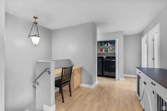 1468 N 220 W, Tooele, UT 84074 - kitchen with washer and dryer, light wood-style floors, dark countertops, and baseboards