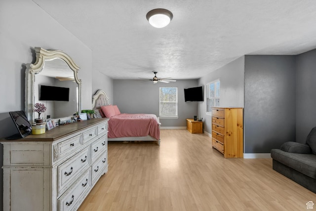 1468 N 220 W, Tooele, UT 84074 - bedroom with light wood-style floors, baseboards, a textured ceiling, and a ceiling fan