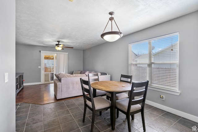 1468 N 220 W, Tooele, UT 84074 - dining space featuring dark tile patterned floors, baseboards, a textured ceiling, and ceiling fan