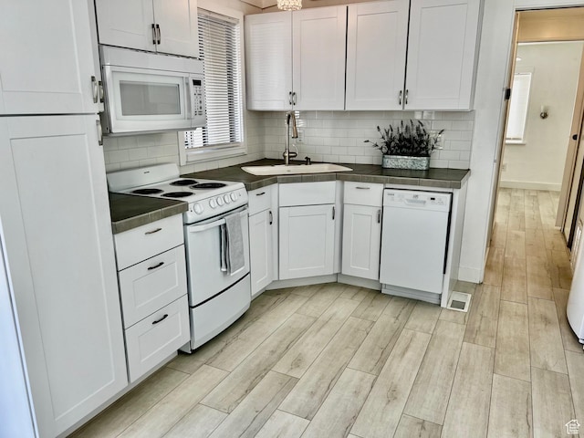 1160 E Telegraph St Unit 126, Washington, UT 84780 - kitchen with a sink, white cabinets, dark countertops, and white appliances