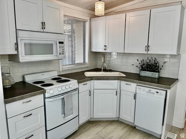 1160 E Telegraph St Unit 126, Washington, UT 84780 - kitchen featuring white appliances, light wood-style flooring, white cabinetry, decorative backsplash, and a sink