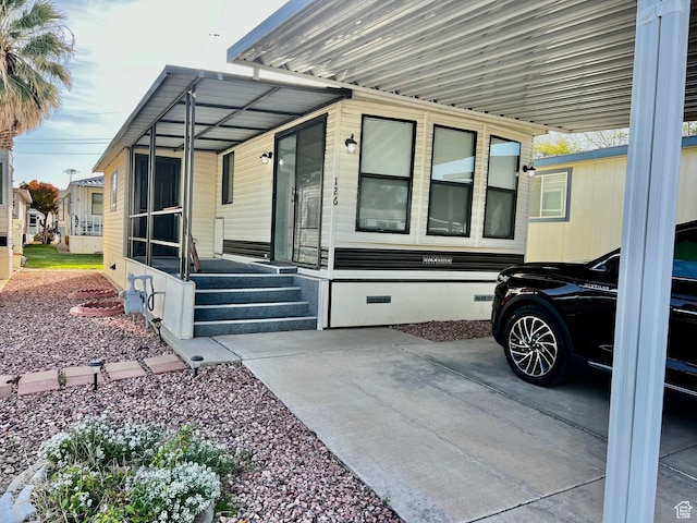 view of side of home featuring crawl space and a carport
