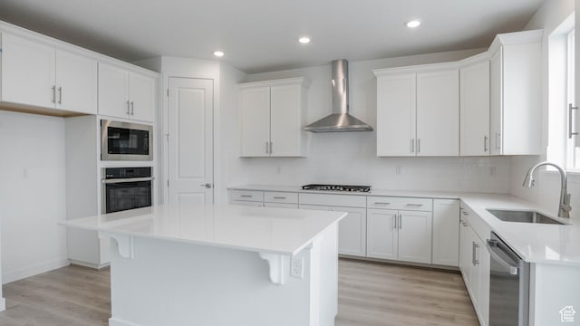 876 W Sika Cir S Unit 205, Saratoga Springs, UT 84045 - kitchen with stainless steel appliances, wall chimney exhaust hood, decorative backsplash, white cabinets, and light wood finished floors