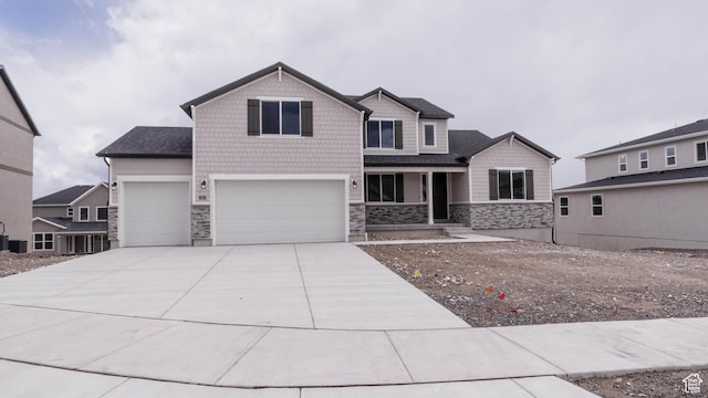 876 W Sika Cir S Unit 205, Saratoga Springs, UT 84045 - craftsman-style home featuring stone siding, a garage, and driveway