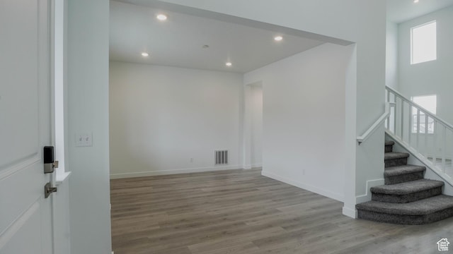876 W Sika Cir S Unit 205, Saratoga Springs, UT 84045 - unfurnished room with wood finished floors, recessed lighting, and stairway
