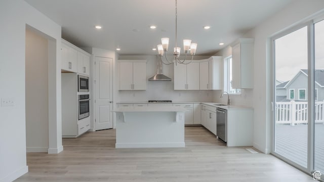 876 W Sika Cir S Unit 205, Saratoga Springs, UT 84045 - kitchen featuring appliances with stainless steel finishes, a center island, a chandelier, light wood-type flooring, and recessed lighting