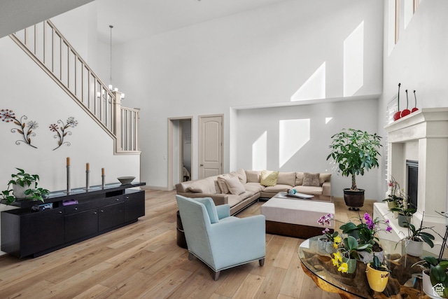 814 N 1490 E, Heber City, UT 84032 - living area featuring a high ceiling, light wood finished floors, a glass covered fireplace, and stairs