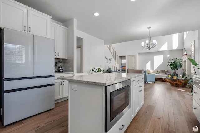 814 N 1490 E, Heber City, UT 84032 - kitchen featuring light wood finished floors, white cabinets, freestanding refrigerator, and built in microwave