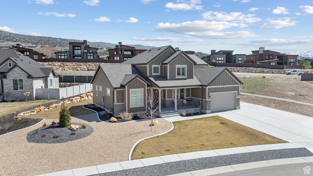 814 N 1490 E, Heber City, UT 84032 - view of front of house with driveway, board and batten siding, an attached garage, fence, and covered porch