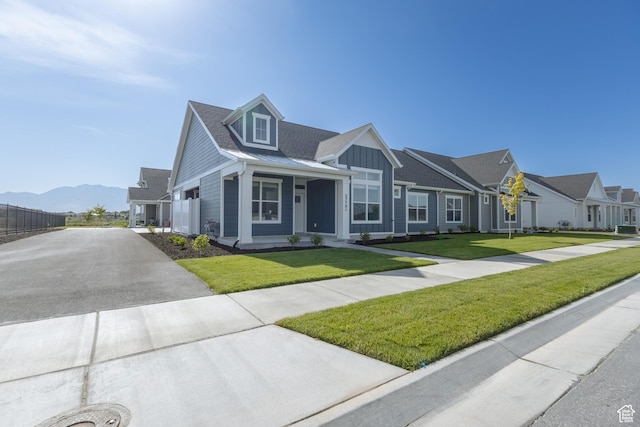 3778 S 4250 W Unit 435, West Haven, UT 84401 - view of front of house featuring driveway, board and batten siding, a residential view, and a mountain view