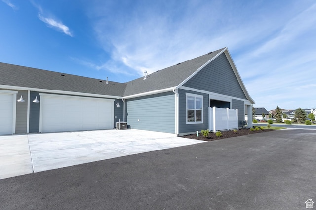 3778 S 4250 W Unit 435, West Haven, UT 84401 - view of home's exterior with concrete driveway, a shingled roof, and an attached garage