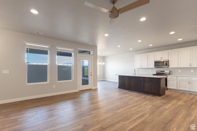 3778 S 4250 W Unit 435, West Haven, UT 84401 - kitchen with stainless steel appliances, tasteful backsplash, light wood finished floors, white cabinetry, and recessed lighting