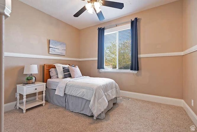 bedroom with ceiling fan, baseboards, and carpet