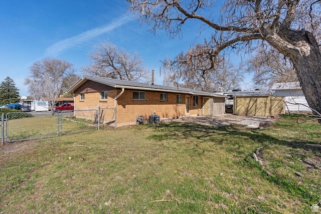 621 N 200 W, Clearfield, UT 84015 - back of property featuring a patio, a gate, brick siding, fence, and a lawn