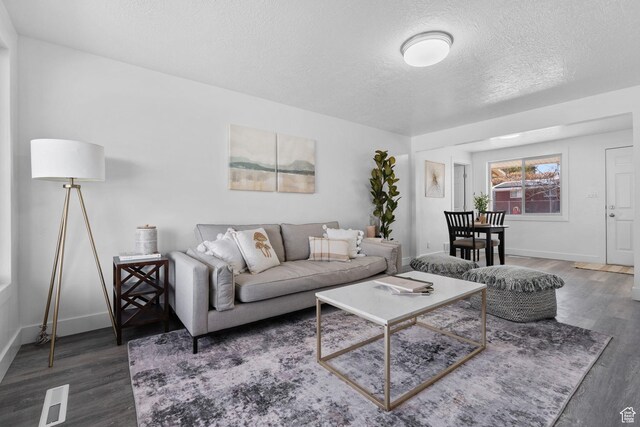 621 N 200 W, Clearfield, UT 84015 - living area featuring a textured ceiling, wood finished floors, baseboards, and visible vents