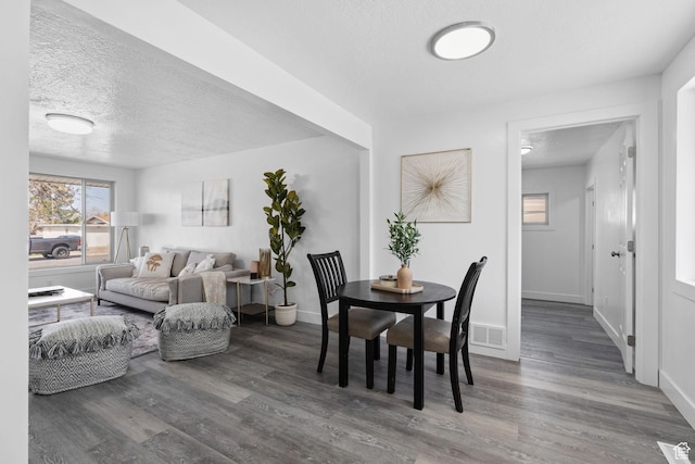 621 N 200 W, Clearfield, UT 84015 - dining area with visible vents, baseboards, wood finished floors, and a textured ceiling