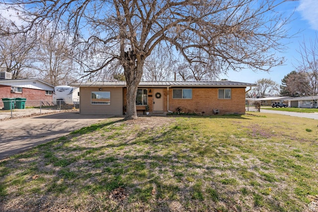 621 N 200 W, Clearfield, UT 84015 - ranch-style house featuring metal roof, fence, brick siding, a front lawn, and driveway