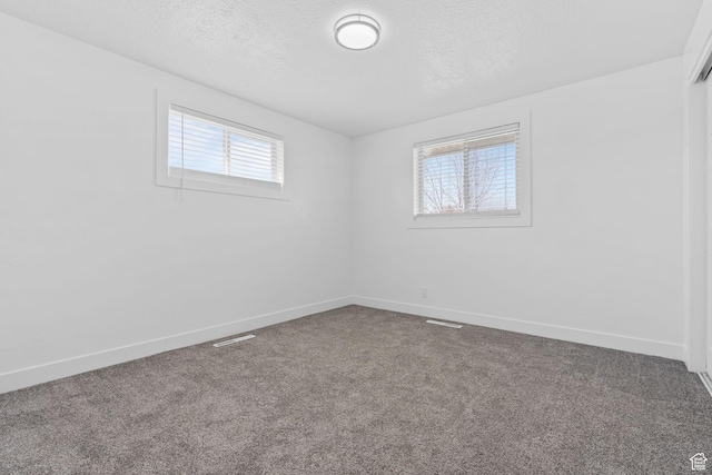 621 N 200 W, Clearfield, UT 84015 - carpeted empty room with visible vents, a textured ceiling, and baseboards