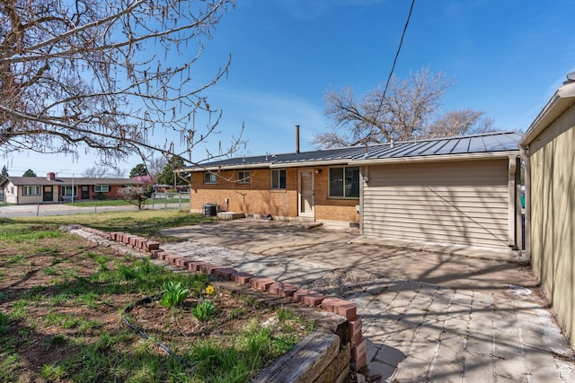 621 N 200 W, Clearfield, UT 84015 - back of house featuring solar panels, a patio area, entry steps, metal roof, and brick siding