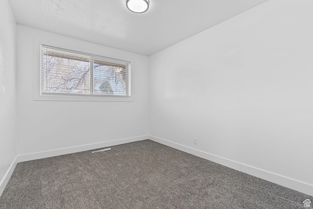 621 N 200 W, Clearfield, UT 84015 - empty room with visible vents, baseboards, and dark carpet