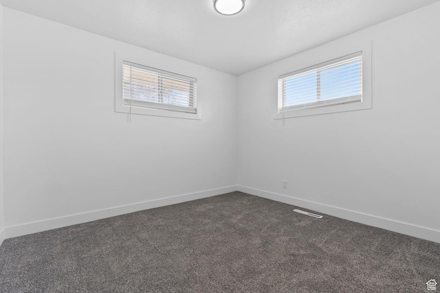 621 N 200 W, Clearfield, UT 84015 - spare room with visible vents, dark colored carpet, and baseboards