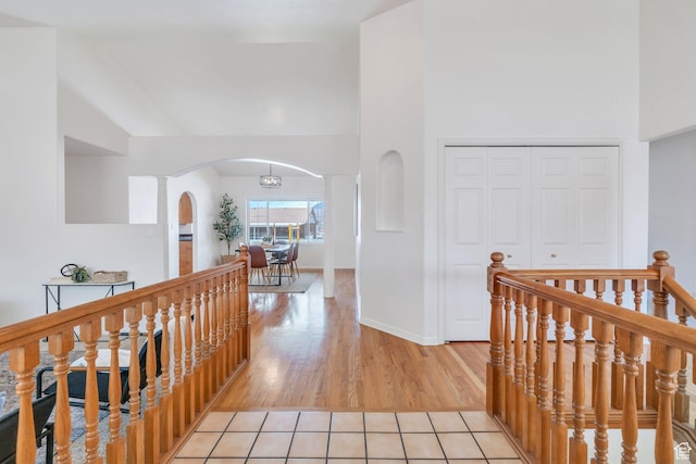 492 W 175 N, Orem, UT 84057 - corridor featuring arched walkways, ornate columns, a towering ceiling, light wood finished floors, and baseboards