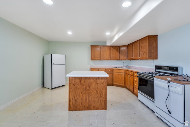 492 W 175 N, Orem, UT 84057 - kitchen featuring recessed lighting, white appliances, a center island, brown cabinetry, and a sink