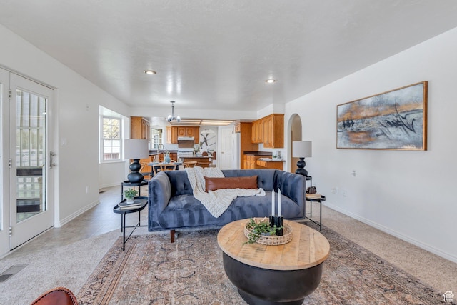 492 W 175 N, Orem, UT 84057 - living room featuring visible vents, baseboards, arched walkways, and an inviting chandelier