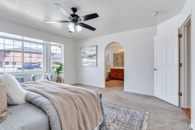 492 W 175 N, Orem, UT 84057 - bedroom with baseboards, arched walkways, a ceiling fan, connected bathroom, and light colored carpet