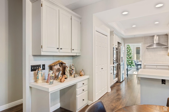 819 N Juniperpoint Dr, Salt Lake City, UT 84103 - kitchen featuring baseboards, dark wood-style floors, light countertops, wall chimney exhaust hood, and decorative backsplash