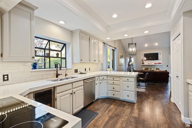 819 N Juniperpoint Dr, Salt Lake City, UT 84103 - kitchen with dark wood finished floors, a peninsula, dishwasher, a sink, and a raised ceiling
