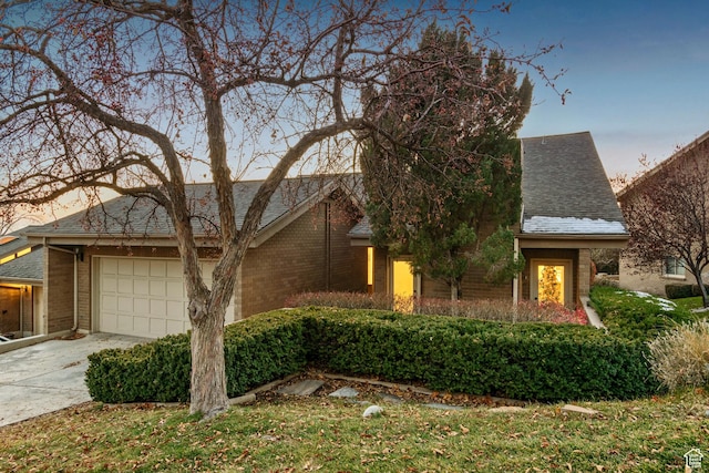 819 N Juniperpoint Dr, Salt Lake City, UT 84103 - view of front of house with brick siding, a shingled roof, driveway, and an attached garage