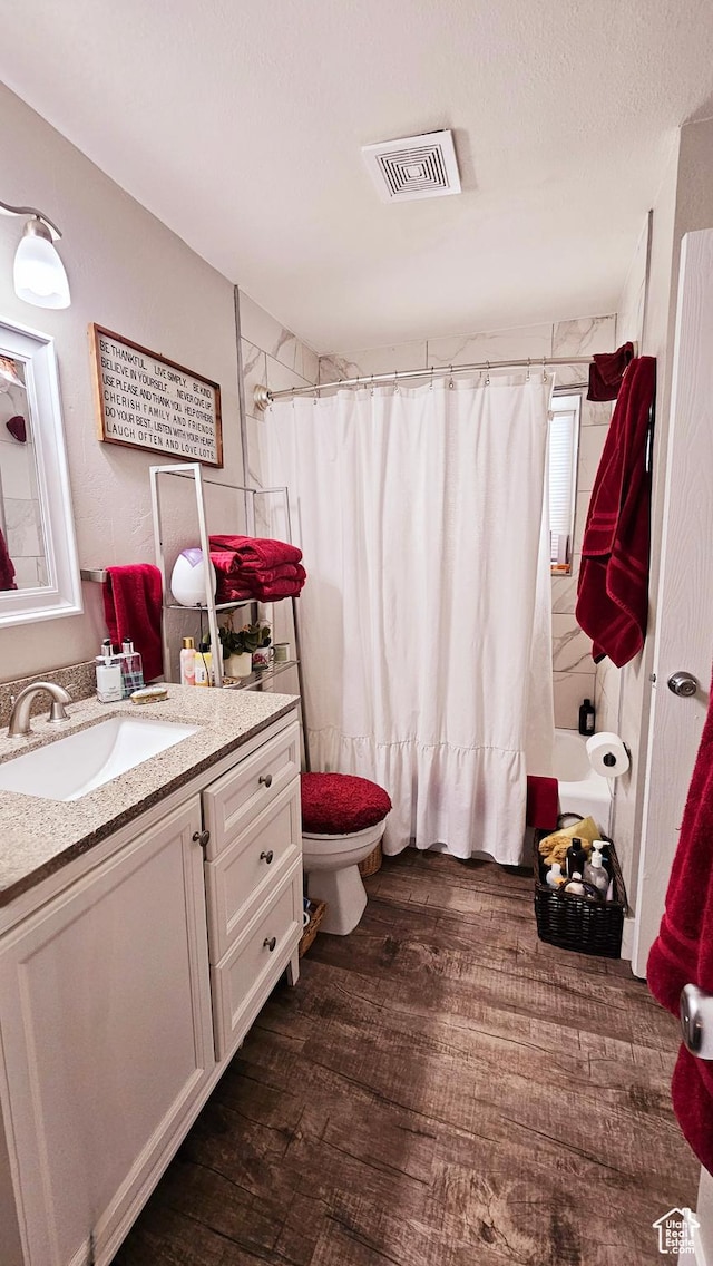 443 S 600 W, Vernal, UT 84078 - bathroom featuring wood finished floors, vanity, toilet, and shower / bath combo