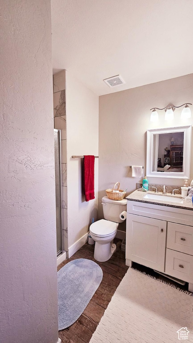 443 S 600 W, Vernal, UT 84078 - full bath featuring a shower stall, wood finished floors, toilet, vanity, and a textured wall