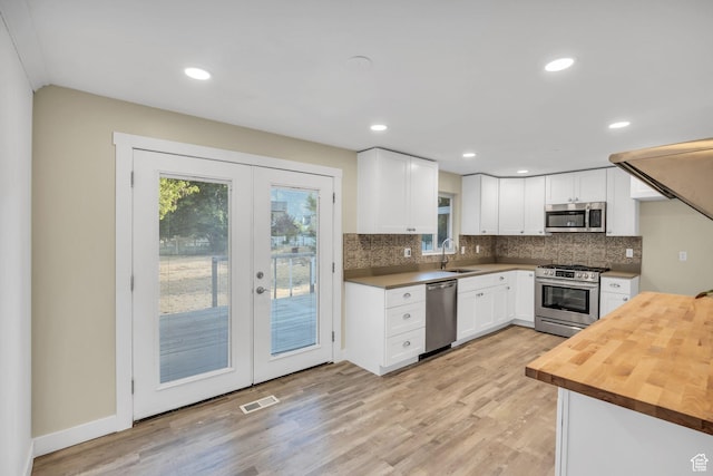 1962 E 7700 S, South Weber, UT 84405 - kitchen featuring butcher block counters, visible vents, appliances with stainless steel finishes, a sink, and french doors