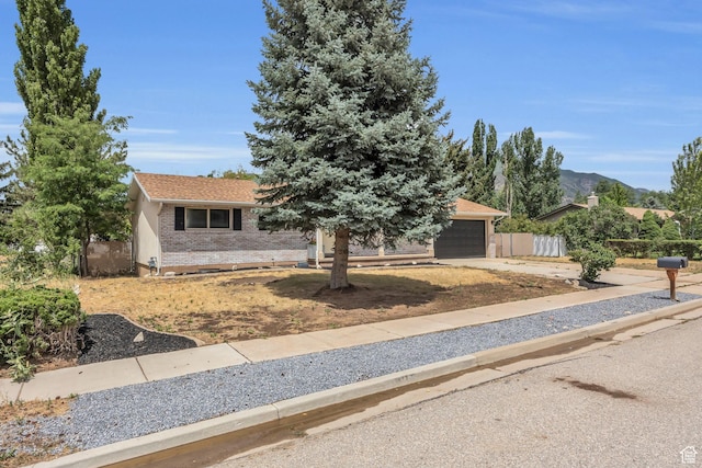 1962 E 7700 S, South Weber, UT 84405 - view of front of property featuring brick siding, fence, a garage, and driveway