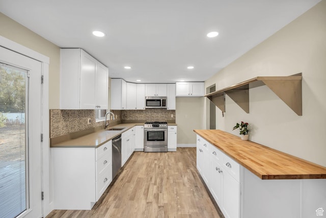 1962 E 7700 S, South Weber, UT 84405 - kitchen with light wood-style floors, butcher block counters, appliances with stainless steel finishes, a sink, and backsplash