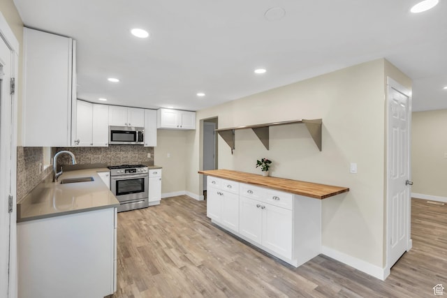 1962 E 7700 S, South Weber, UT 84405 - kitchen featuring tasteful backsplash, light wood-style flooring, wooden counters, stainless steel appliances, and a sink