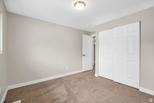 1962 E 7700 S, South Weber, UT 84405 - unfurnished bedroom with carpet floors, baseboards, and a closet