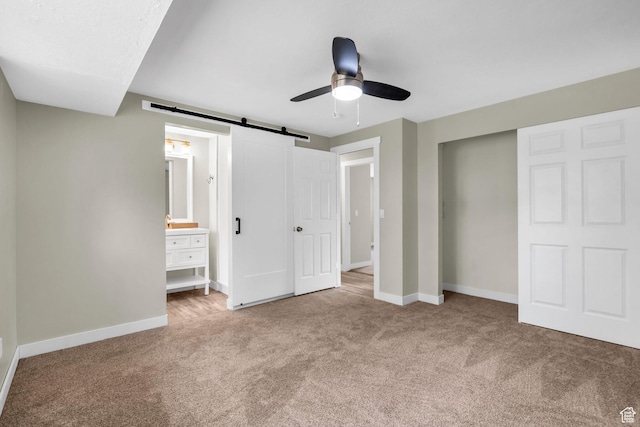 1962 E 7700 S, South Weber, UT 84405 - unfurnished bedroom with a barn door, ceiling fan, baseboards, and carpet
