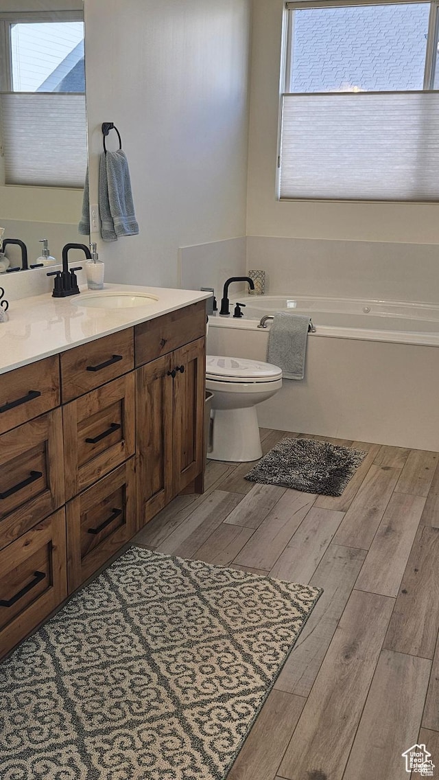 2345 E Cherry Ln, Layton, UT 84040 - bathroom featuring a bath, toilet, vanity, and wood finished floors