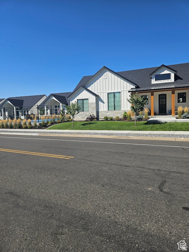 2345 E Cherry Ln, Layton, UT 84040 - modern inspired farmhouse featuring board and batten siding, a front yard, and a residential view