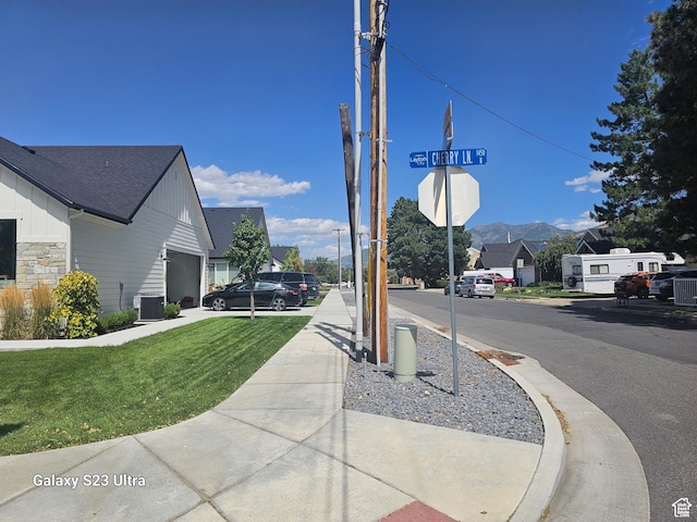 2345 E Cherry Ln, Layton, UT 84040 - view of road with traffic signs, sidewalks, a mountain view, and curbs
