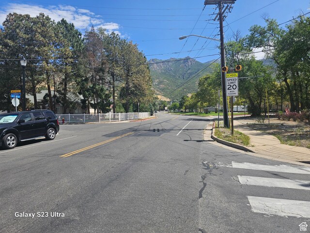 2345 E Cherry Ln, Layton, UT 84040 - view of street featuring a mountain view, traffic signs, street lights, curbs, and sidewalks